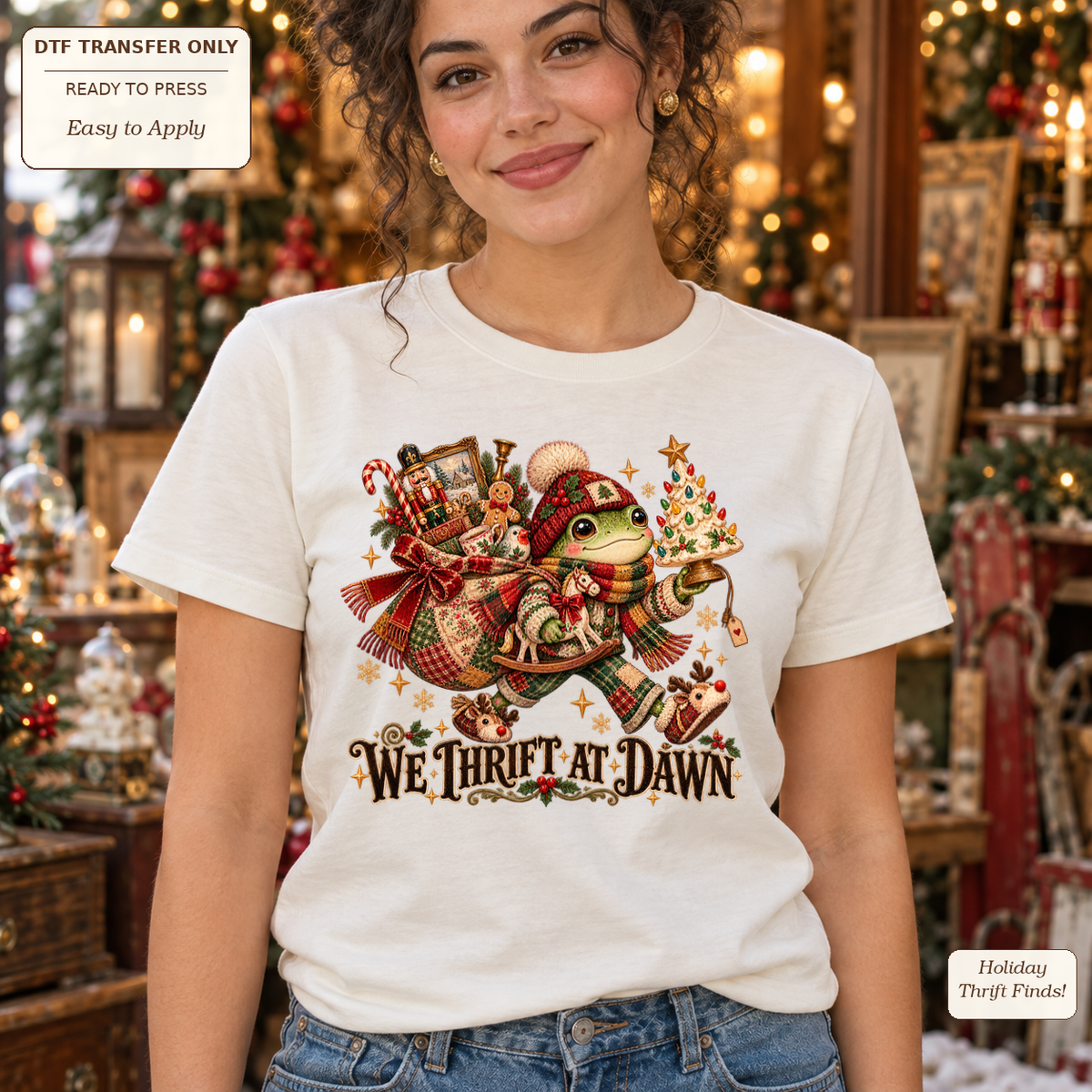 Woman wearing a cream tee with We Thrift at Dawn text and a frog in winter clothing carrying Christmas treasures.