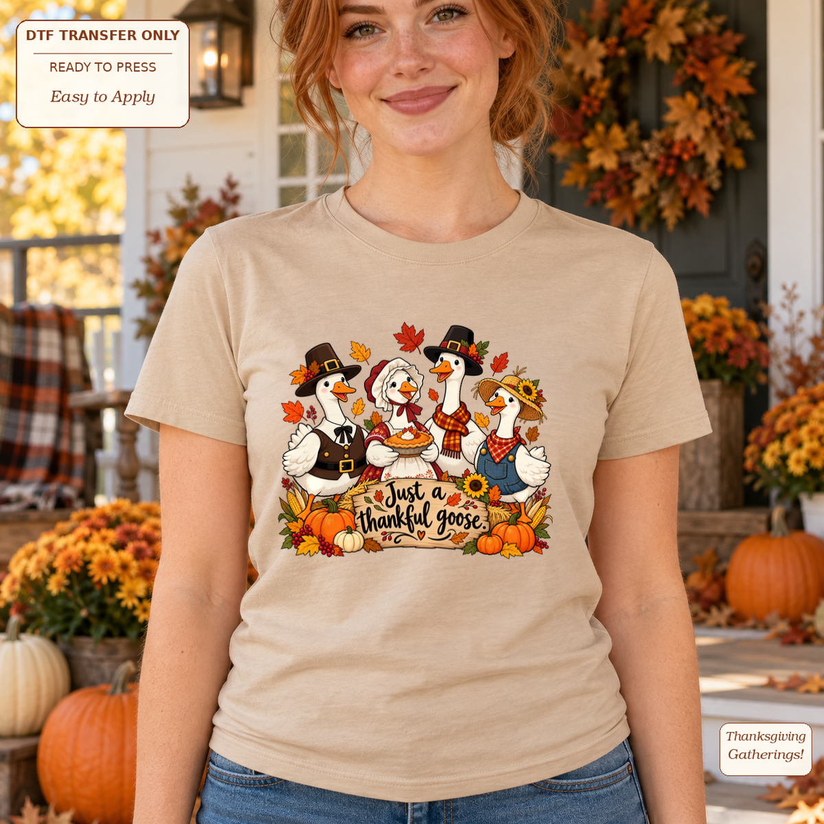 Woman wearing a cream tee with four geese in Thanksgiving outfits, pumpkins and Just a thankful goose text.