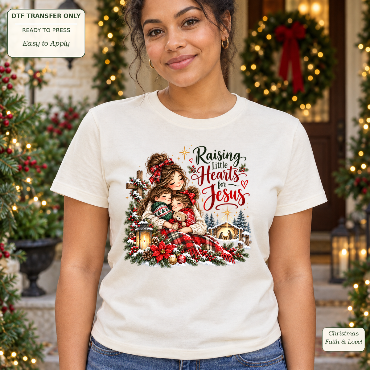 Woman wearing a cream tee with Raising Little Hearts for Jesus text, a mother cuddling children and a snowy Christmas scene.