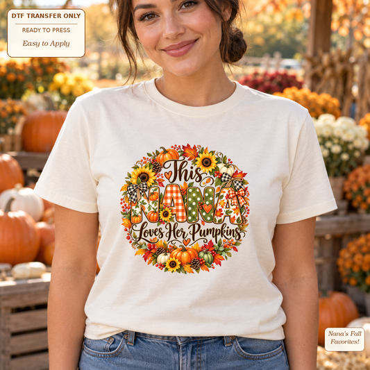 Woman wearing a cream tee with This Nana Loves Her Pumpkins lettering inside a sunflower and pumpkin wreath.