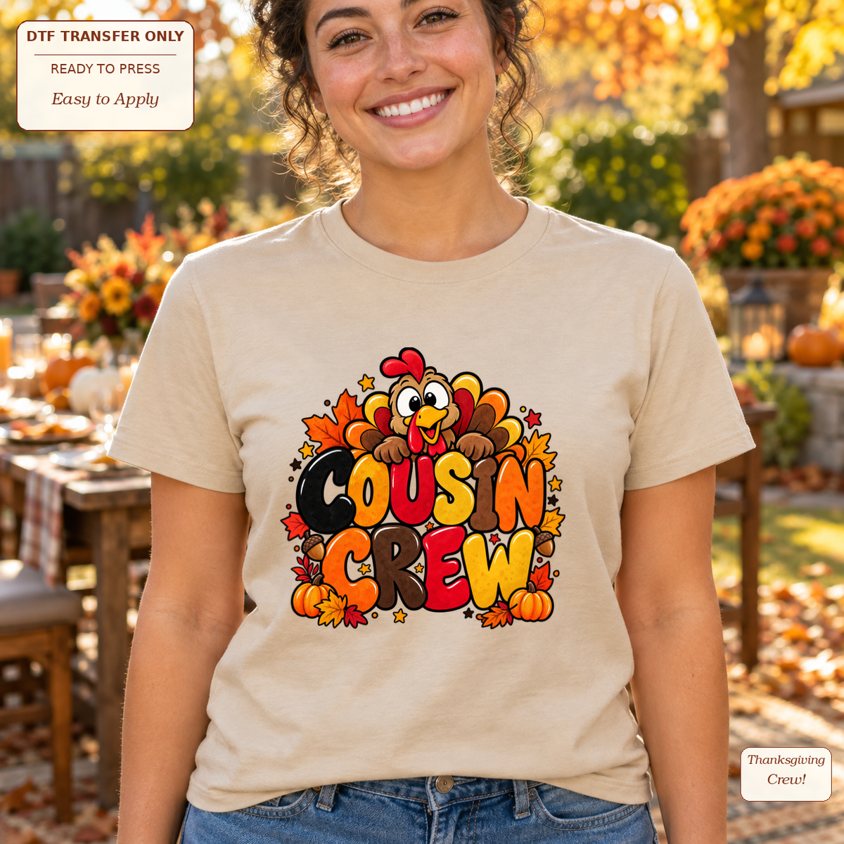 Woman wearing a cream tee with orange and brown Cousin Crew lettering, a cartoon turkey and autumn leaves.