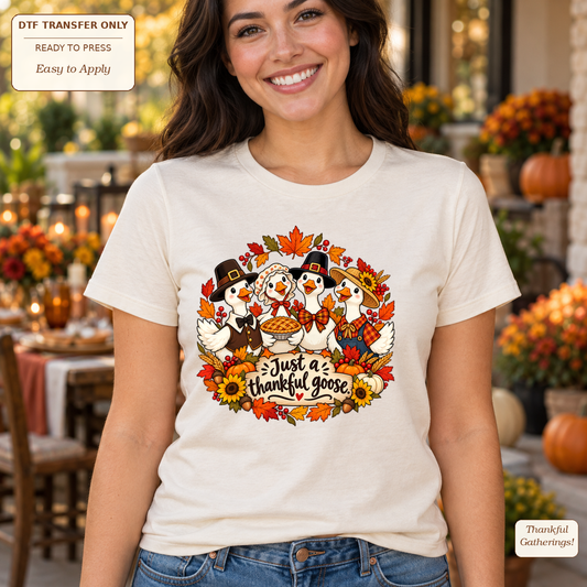 Woman wearing a cream tee with Thanksgiving geese, pie, sunflowers and Just a thankful goose lettering.