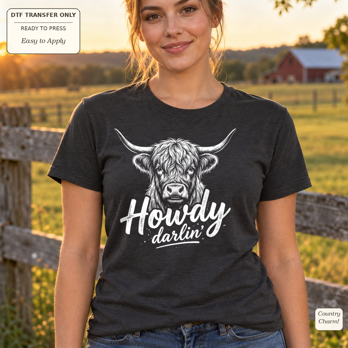 Woman wearing a charcoal tee with a white Highland cow illustration above Howdy darlin script.