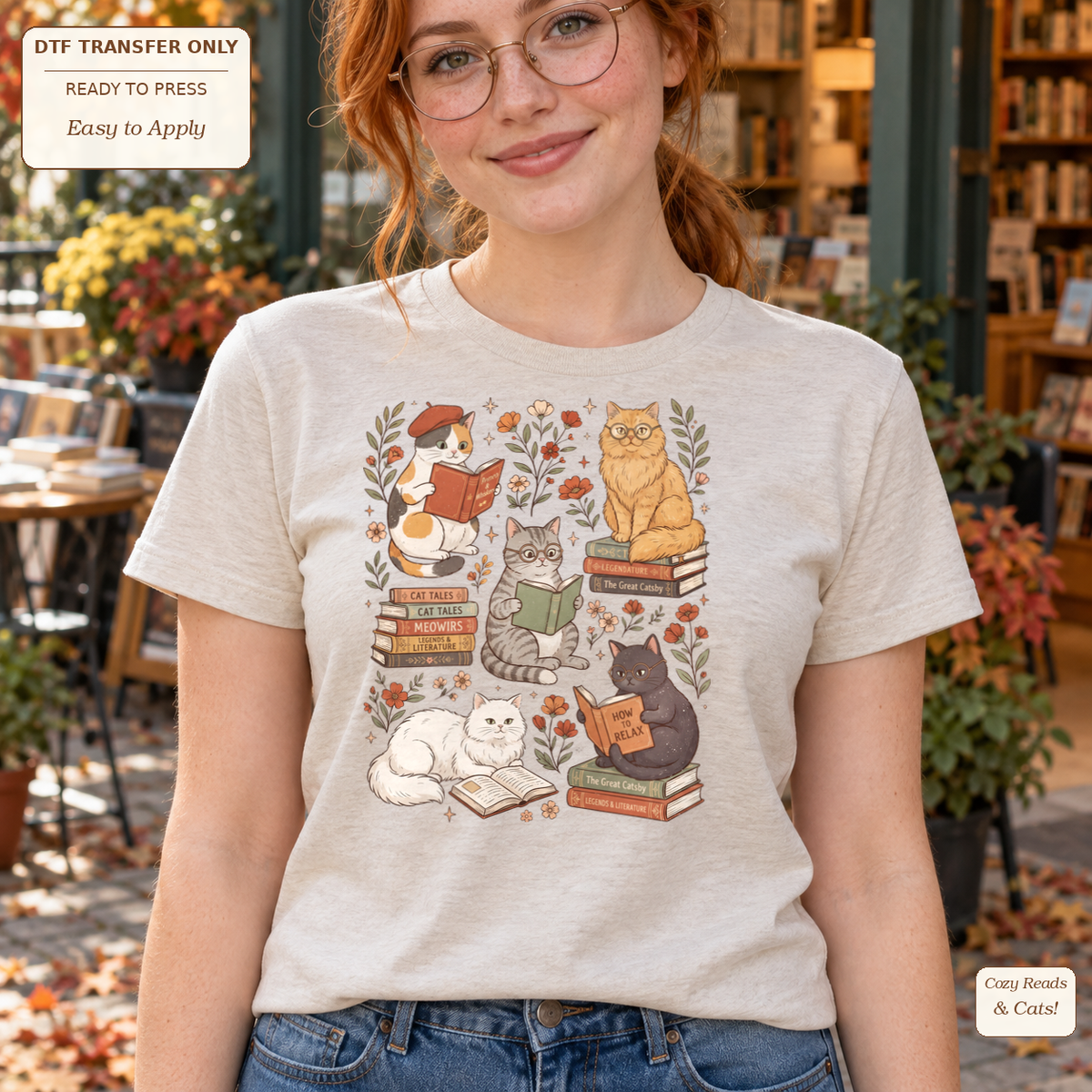 Woman wearing a light gray tee with illustrated cats reading and resting on books among small botanical accents.