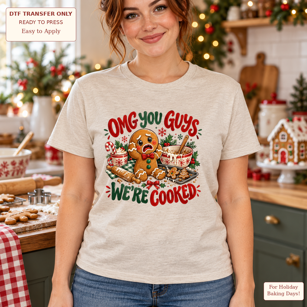 Woman wearing a light gray tee with OMG You Guys We’re Cooked lettering and a gingerbread character in a holiday baking scene.