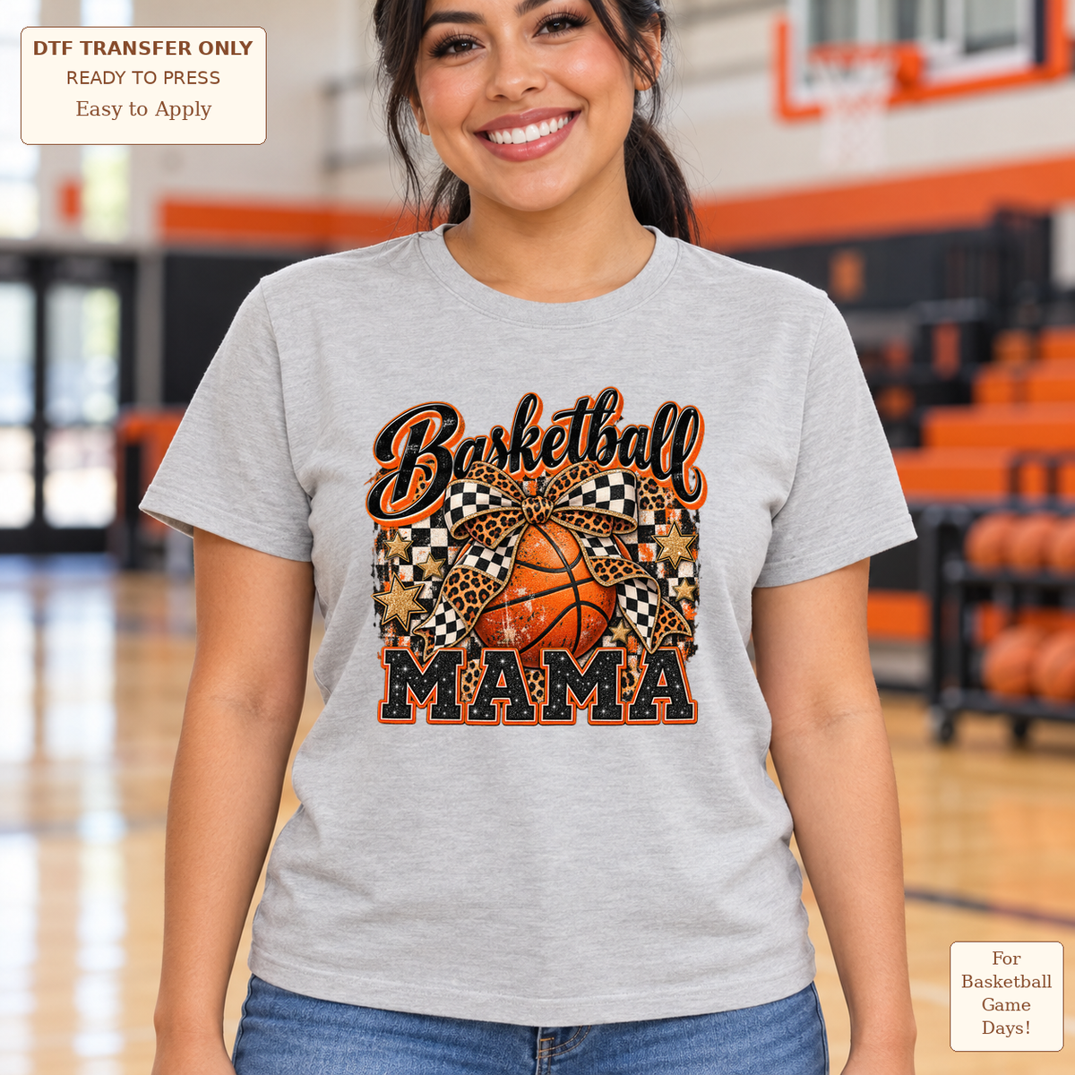 Woman wearing a gray tee with Basketball Mama lettering, a basketball and decorative black, white and orange patterned bows.