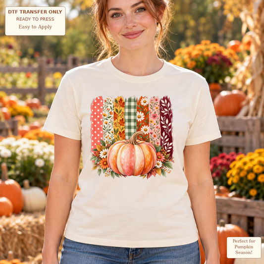 Woman wearing a cream tee with a pink-orange pumpkin, flowers and vertical floral, gingham and leaf-patterned strips.