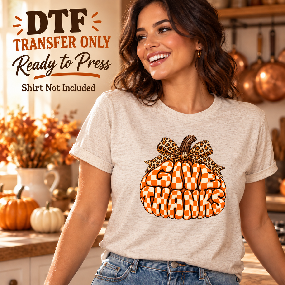 Woman wearing a light beige tee with orange checkerboard Give Thanks letters forming a pumpkin topped by a leopard bow.