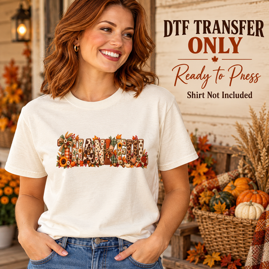 Woman wearing a cream tee with THANKFUL letters in mixed autumn patterns with seasonal flowers and pumpkins.