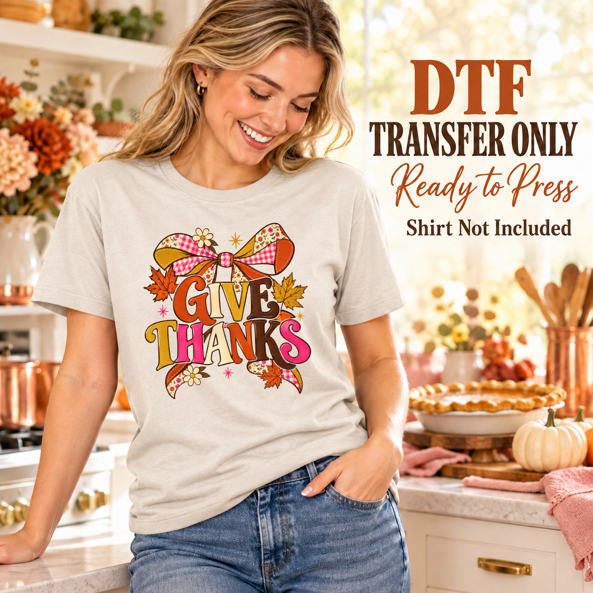 Woman wearing a light gray tee with colorful Give Thanks letters and a large patterned autumn bow.