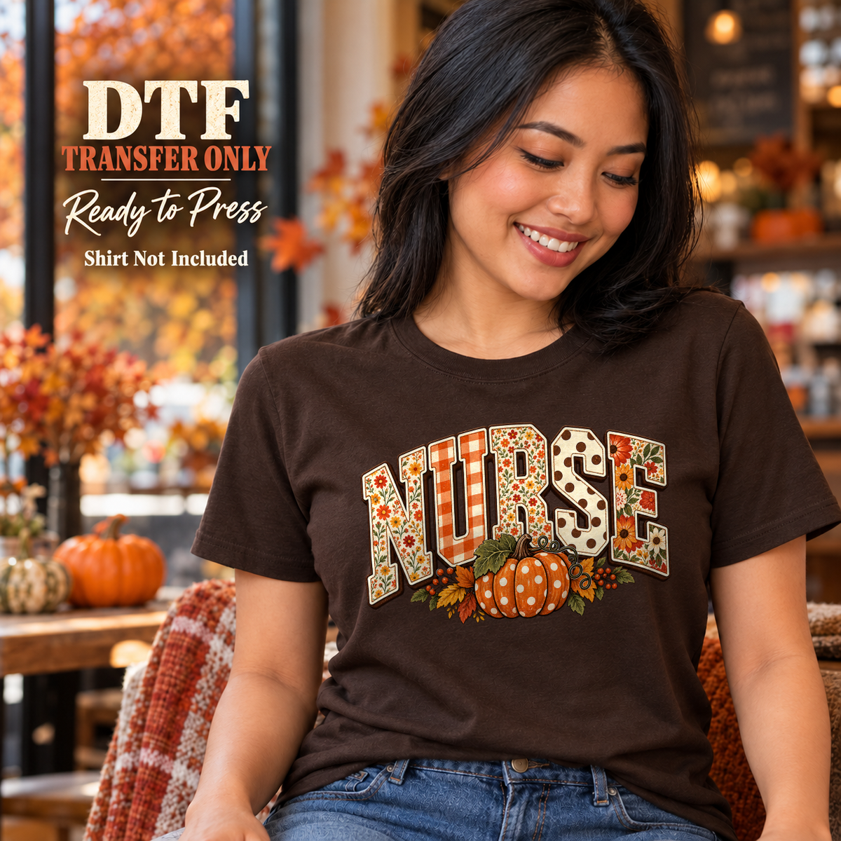 Woman wearing a brown tee with patterned NURSE letters above orange pumpkins and fall foliage.