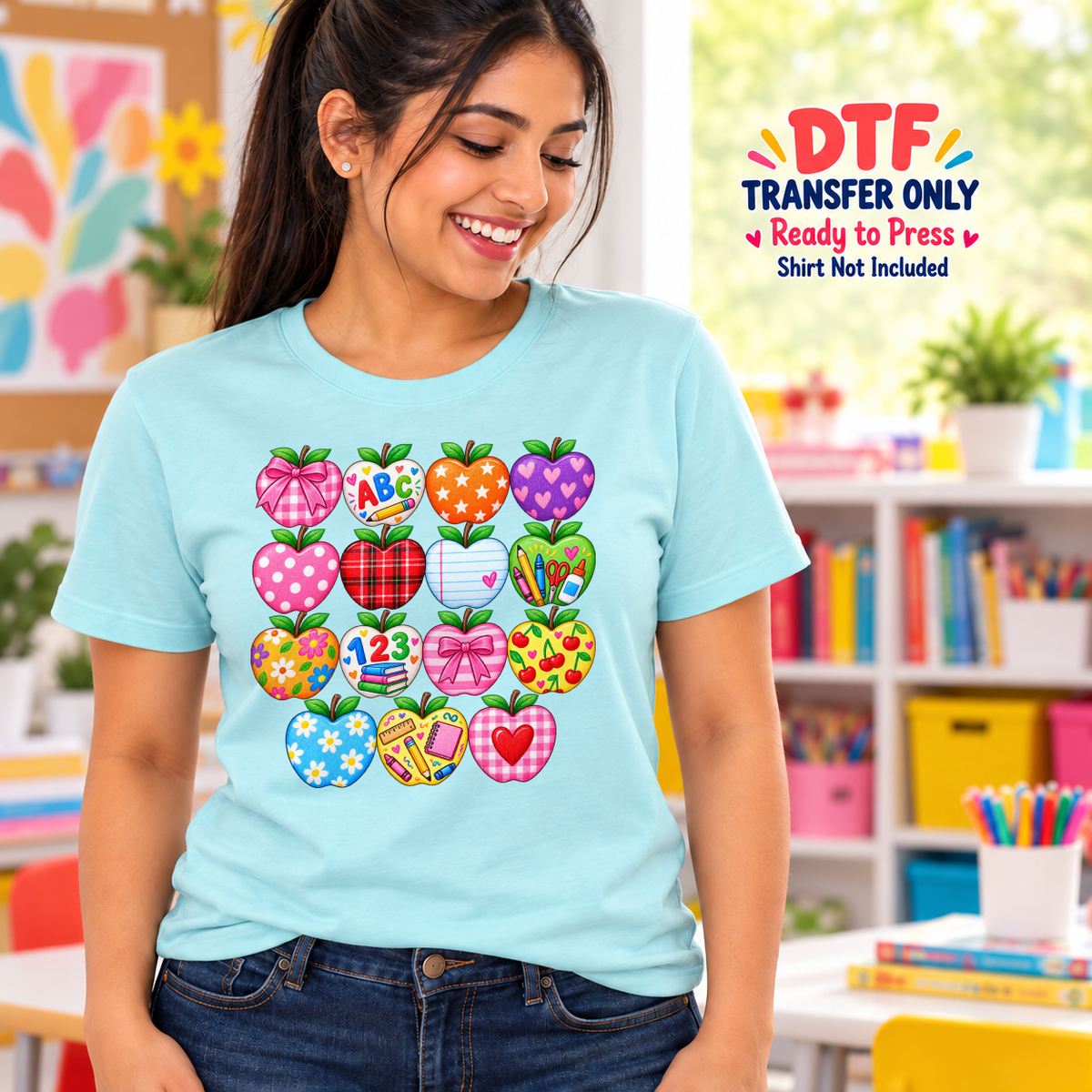 Woman in a turquoise tee with a grid of colorful apples featuring patterns, ABC lettering and numbers.