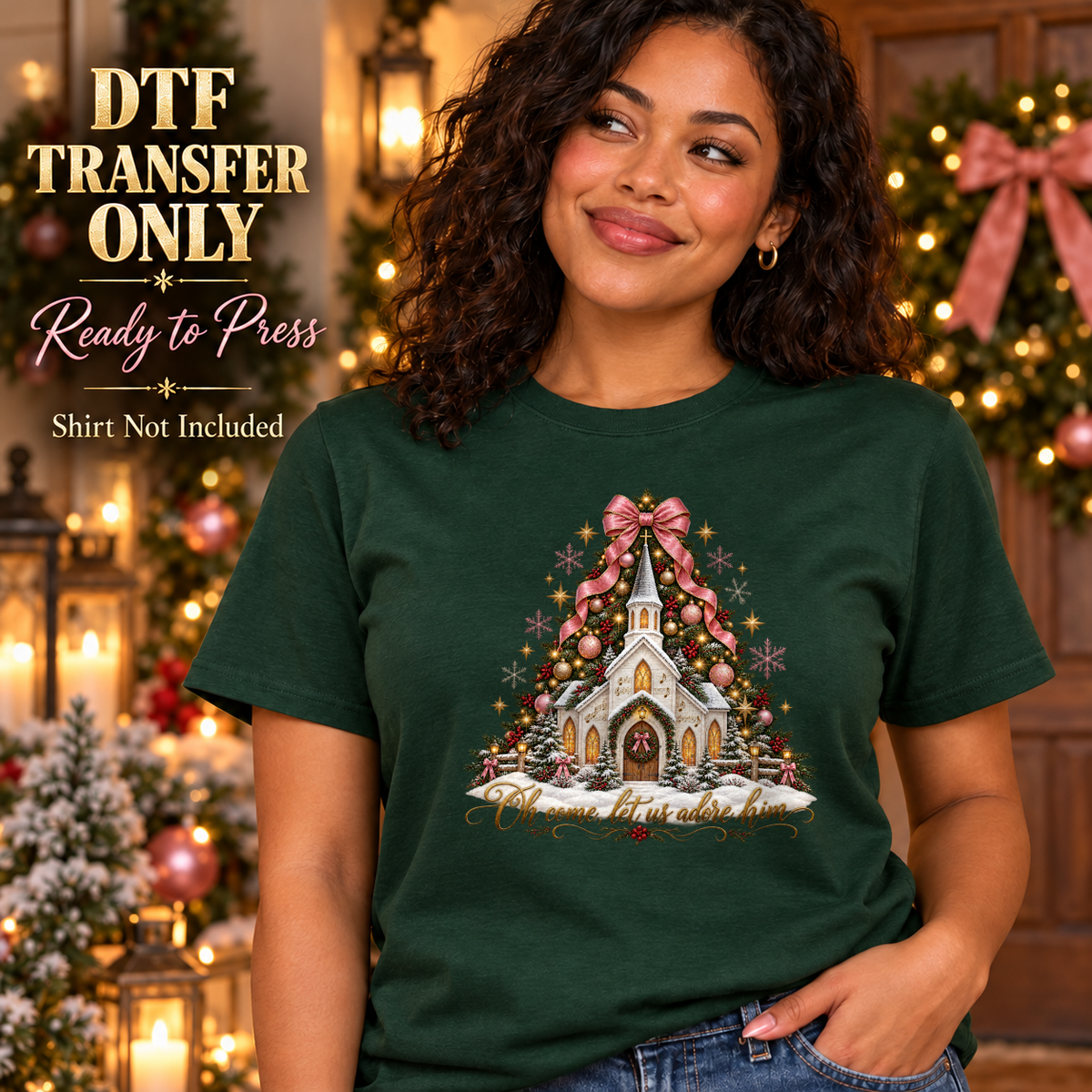 Woman wearing a dark green tee with a snowy church, decorated Christmas tree, pink ribbon and Oh Come Let Us Adore Him script.