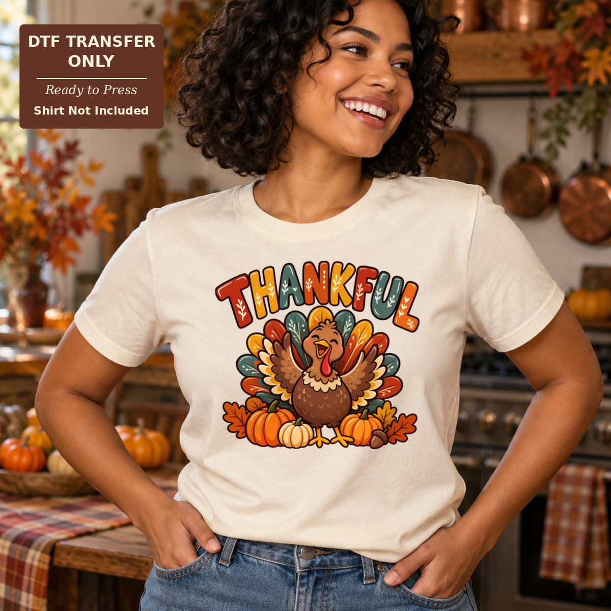 Woman wearing a cream tee with colorful THANKFUL lettering above a smiling turkey, pumpkins and autumn leaves.