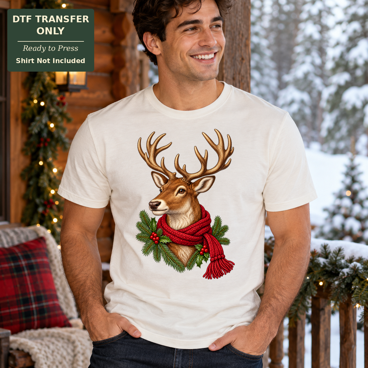 Man wearing a cream tee with an antlered deer in a red scarf framed by evergreen branches and red berries.
