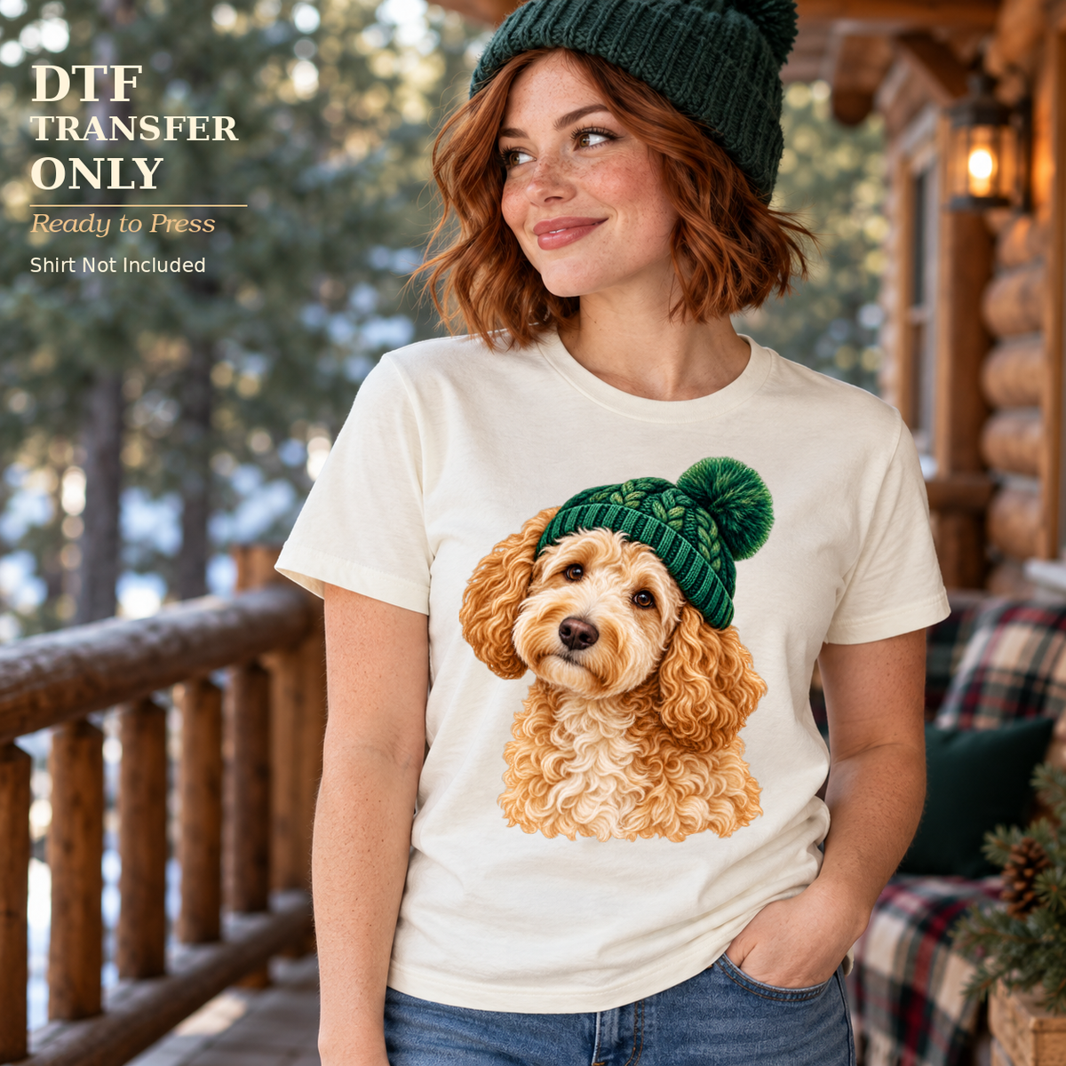 Woman in a white shirt displaying a curly tan puppy in a green knit beanie, standing on a snowy cabin porch.