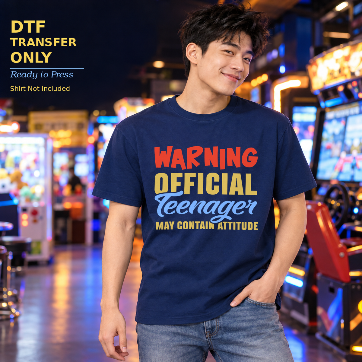 Young man wearing a navy shirt reading Warning Official Teenager May Contain Attitude in an arcade.