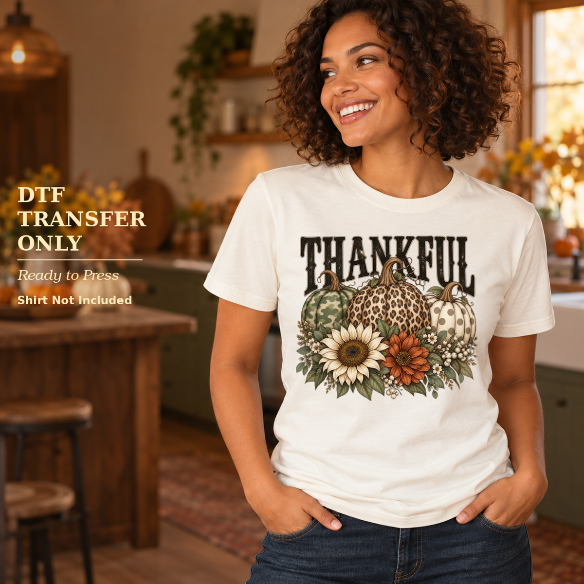 Woman in a white shirt with Thankful lettering, leopard-pattern pumpkins, and fall flowers in a warm kitchen.
