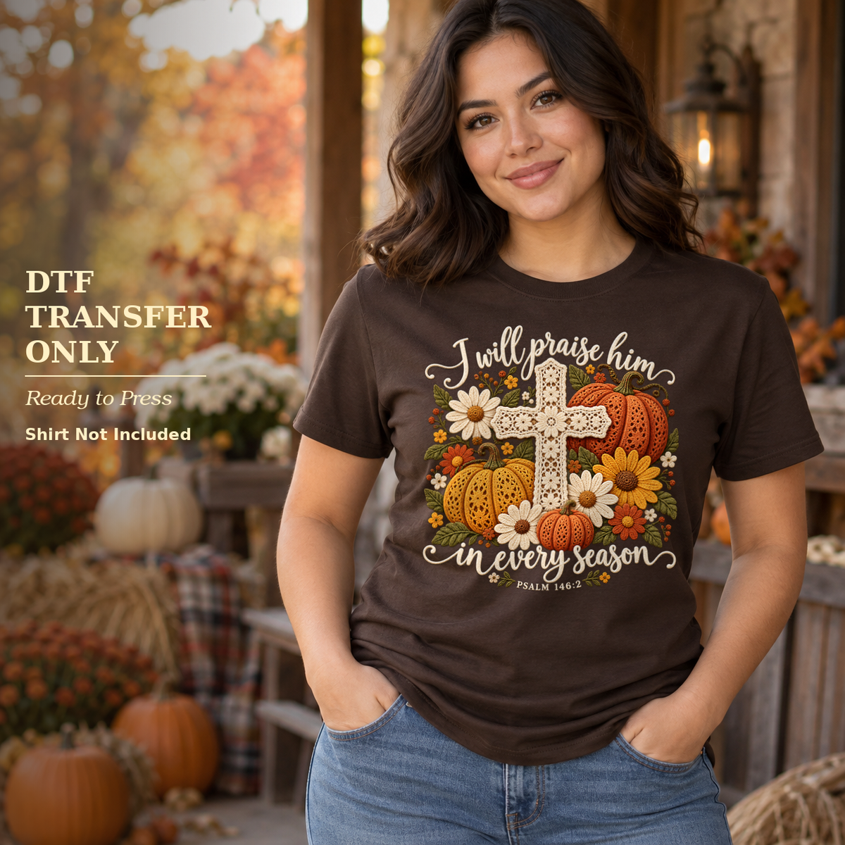 Woman in a brown shirt with I Will Praise Him in Every Season wording, a floral cross, and pumpkins on a fall porch.