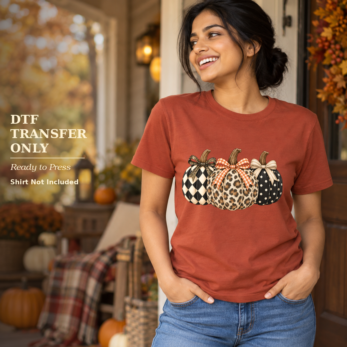 Woman in a rust shirt with three bow-topped pumpkins in checkerboard, leopard, and dotted patterns on a fall porch.