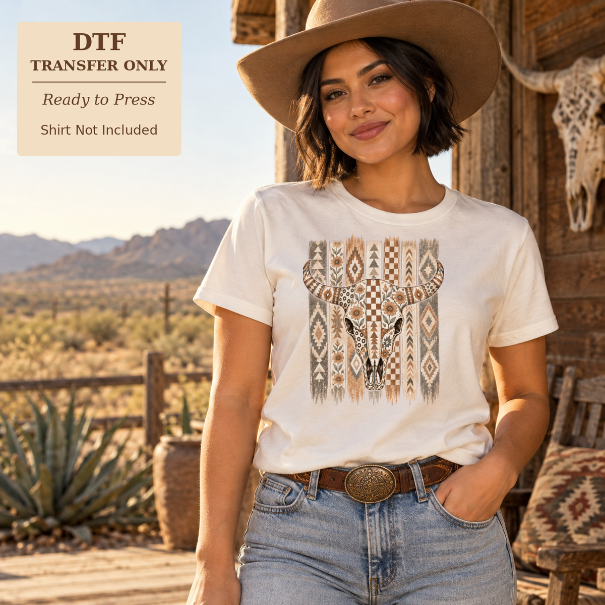 Woman in a white shirt and cowboy hat displaying a longhorn skull over a neutral geometric pattern in a desert setting.