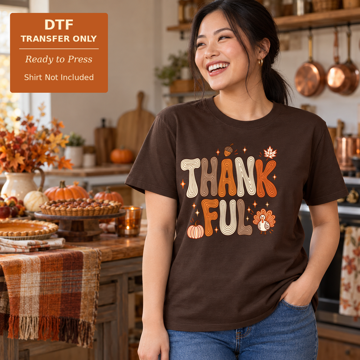 Woman wearing a brown shirt with rounded Thankful lettering and small pumpkins, leaves, and flowers in a fall kitchen.