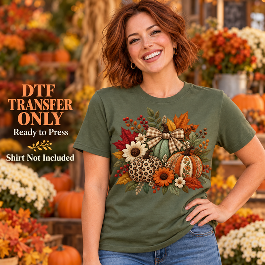 Woman in an olive green shirt with a fall bouquet of flowers, patterned pumpkins, leaves, and a gingham bow at a garden market.