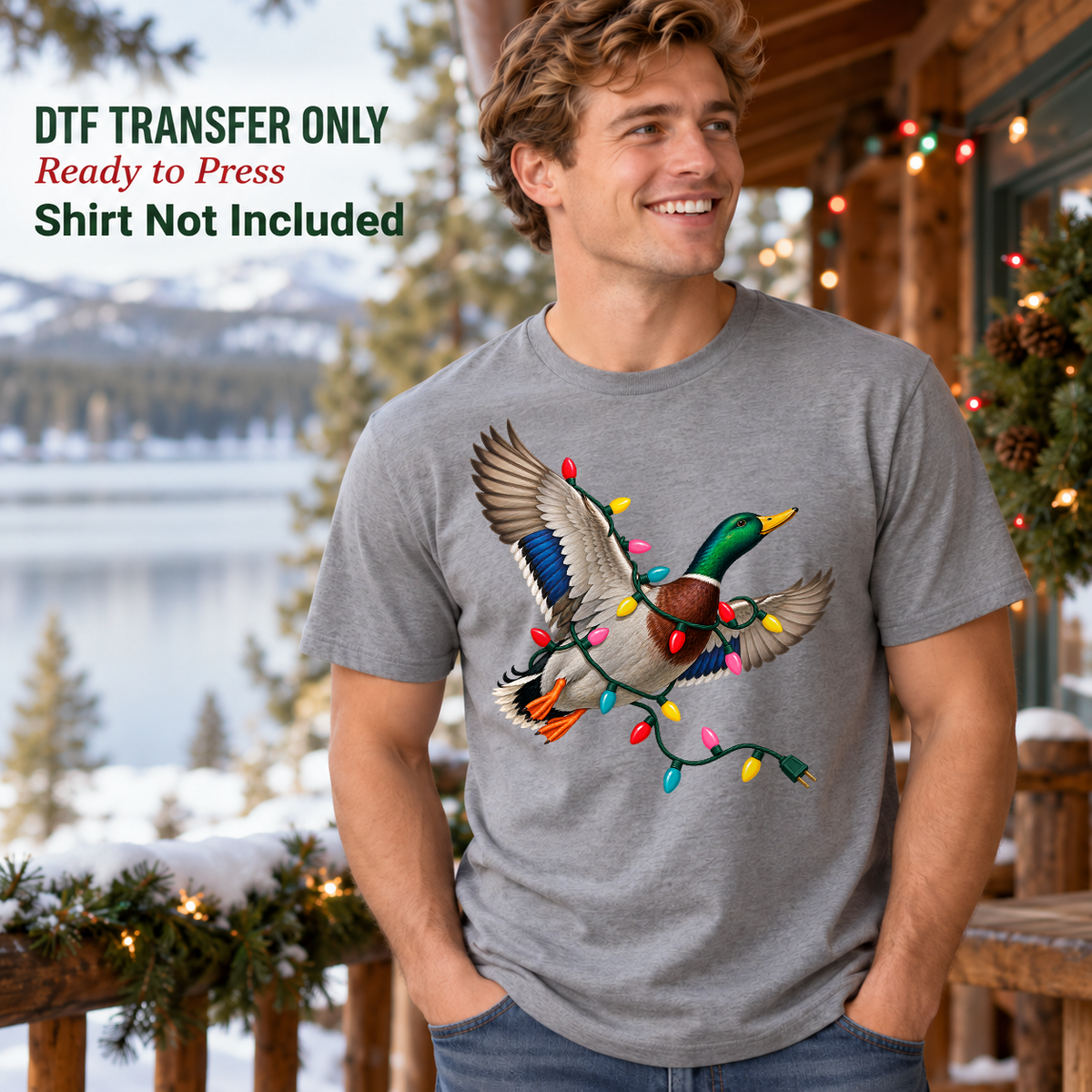 Man wearing a grey shirt with a flying mallard duck wrapped in colorful Christmas lights on a snowy porch.