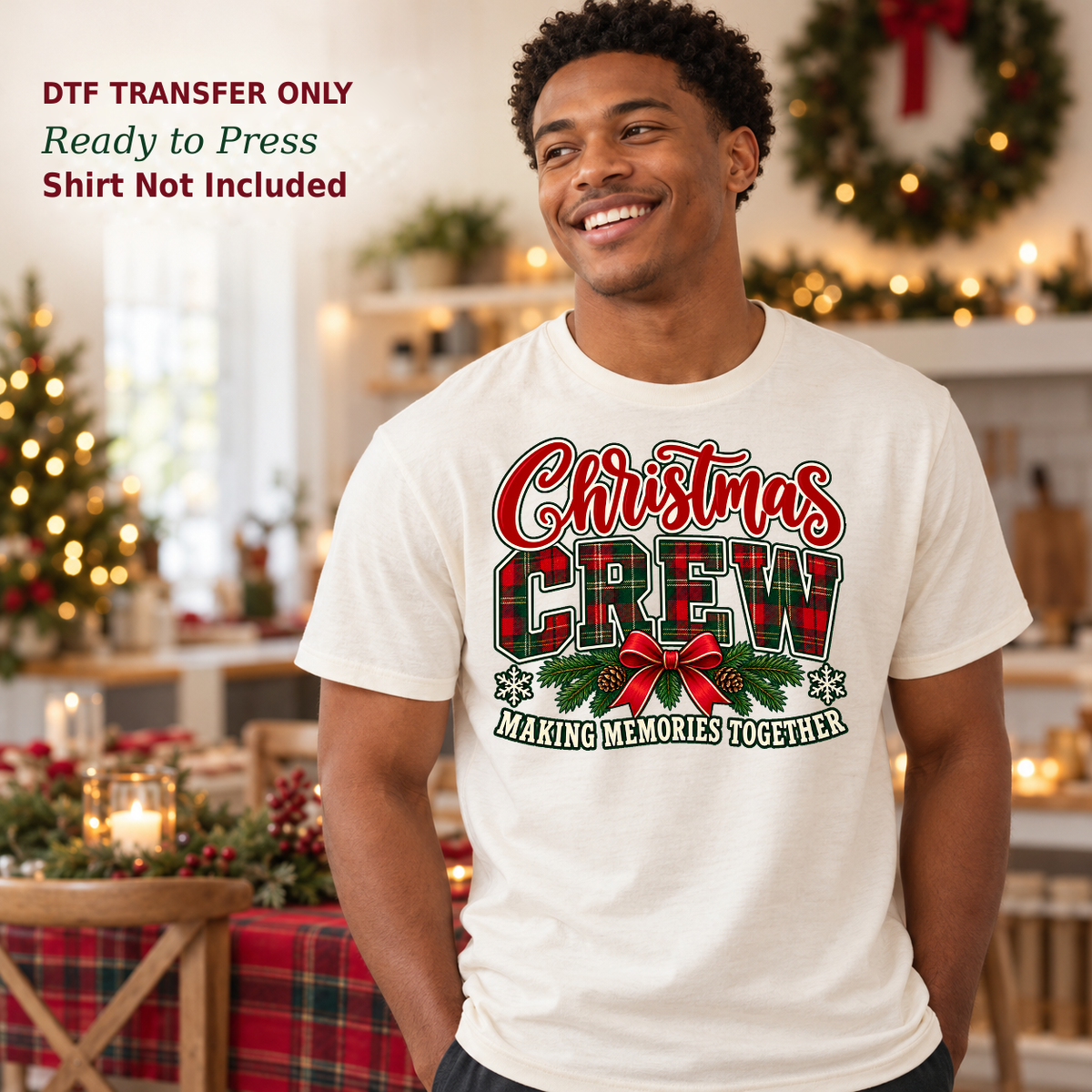 Man wearing a white Christmas Crew Making Memories Together shirt with plaid letters and a red bow in a holiday kitchen.