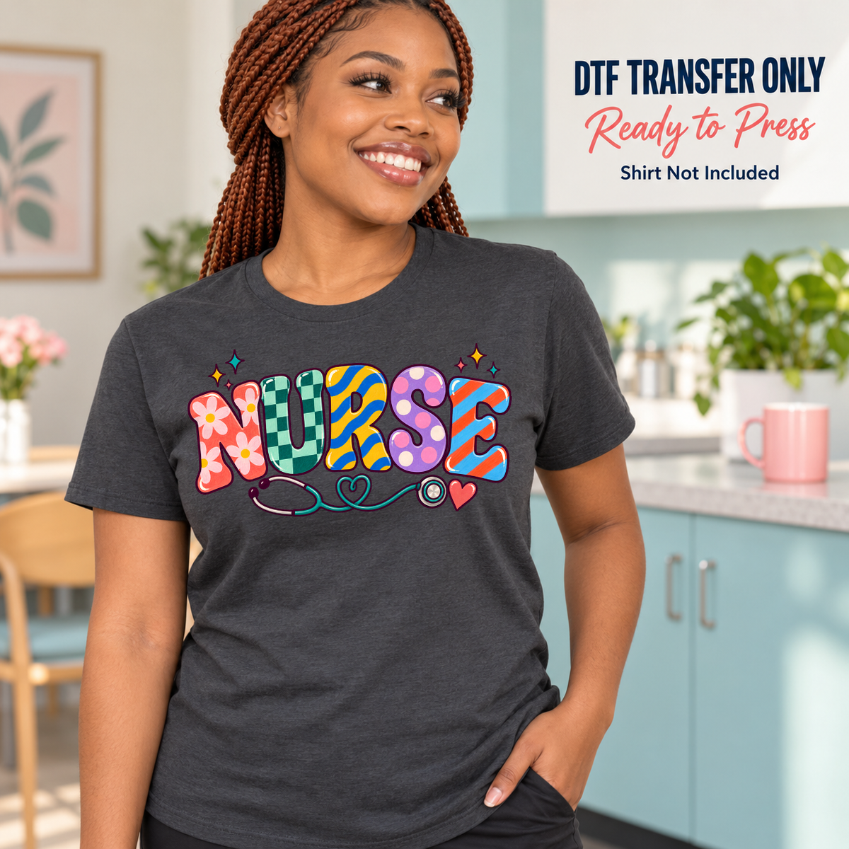 Woman wearing a charcoal shirt with colorful patterned Nurse lettering and a stethoscope graphic in a clinical setting.