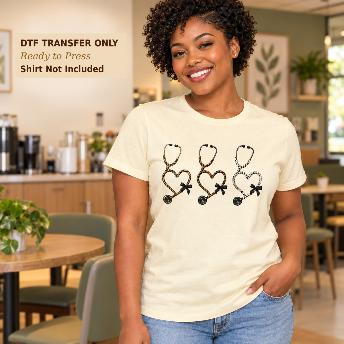 Woman in a cream shirt with three heart-shaped stethoscopes in a neutral leopard-style pattern with small bows in a cafe.
