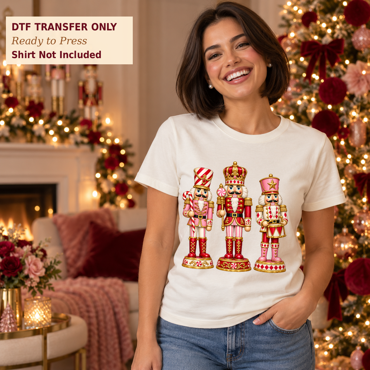 Woman in a white shirt with three ornate pink, red, and gold Christmas nutcrackers in a decorated living room.