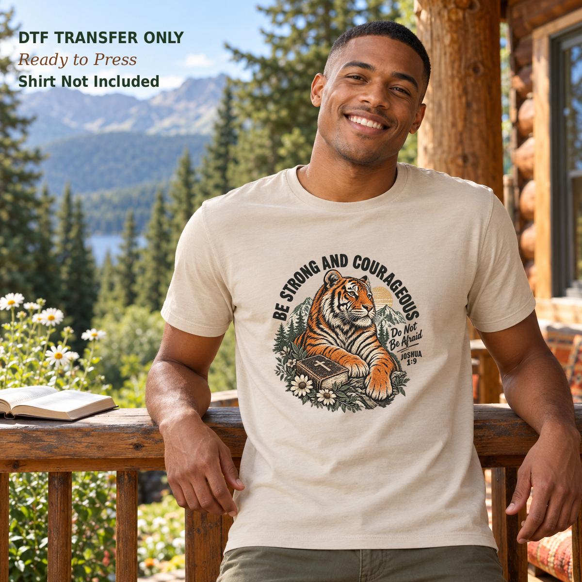 Man in a cream shirt with a tiger, Bible, flowers, and Be Strong and Courageous Joshua 1:9 wording on a mountain cabin porch.