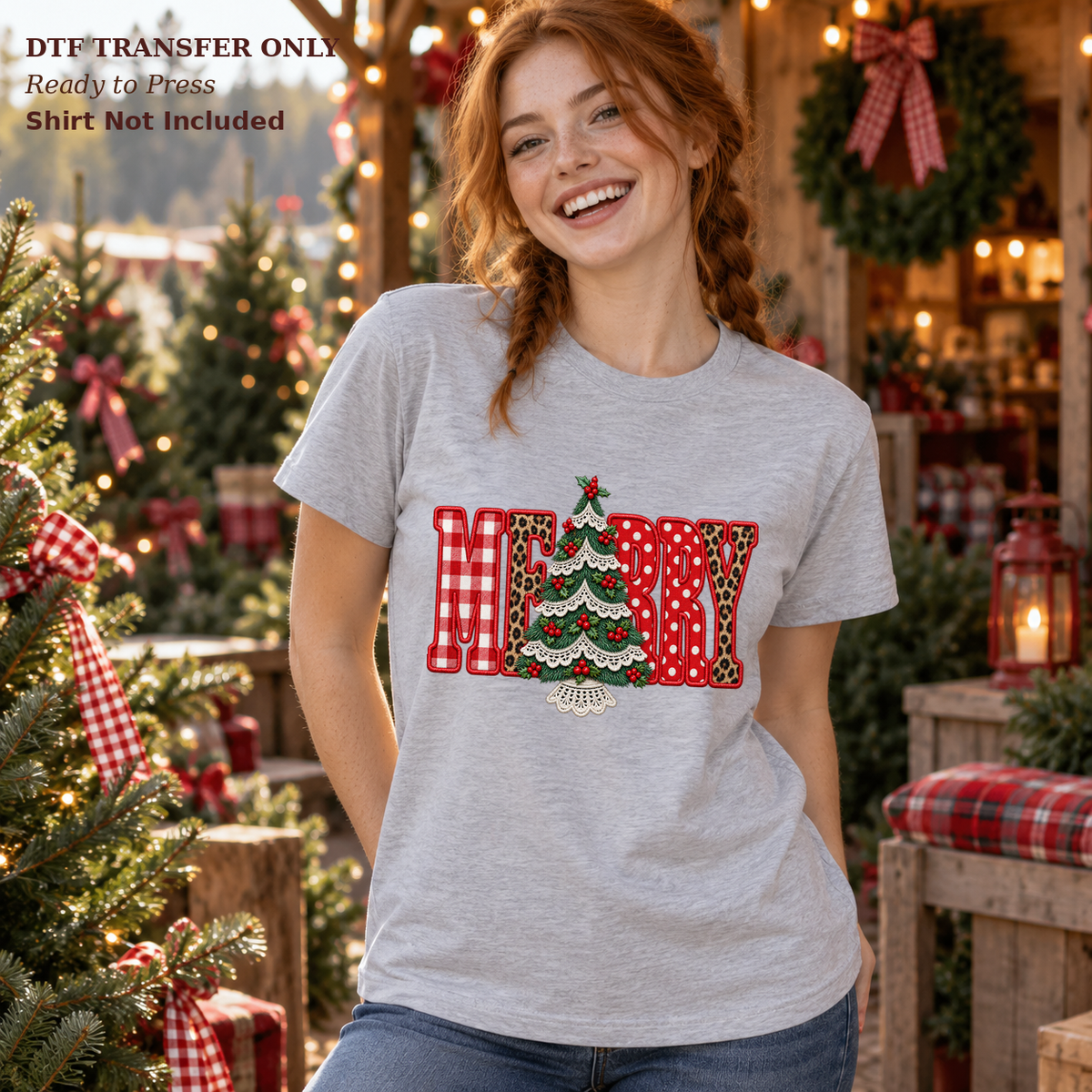 Woman wearing a grey shirt with Merry lettering in red patchwork patterns and a green Christmas tree on a decorated porch.