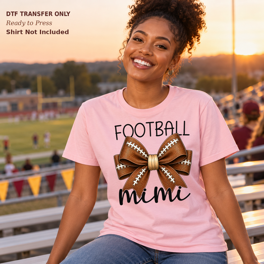 Woman in a pink tee with Football Mimi lettering in dark script and a football-patterned bow.