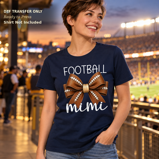 Woman in a navy tee with Football Mimi lettering in light script and a brown football bow.