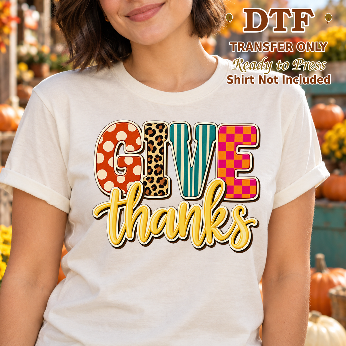 Woman in a cream tee with multicolored patterned GIVE lettering and yellow Thanks script.