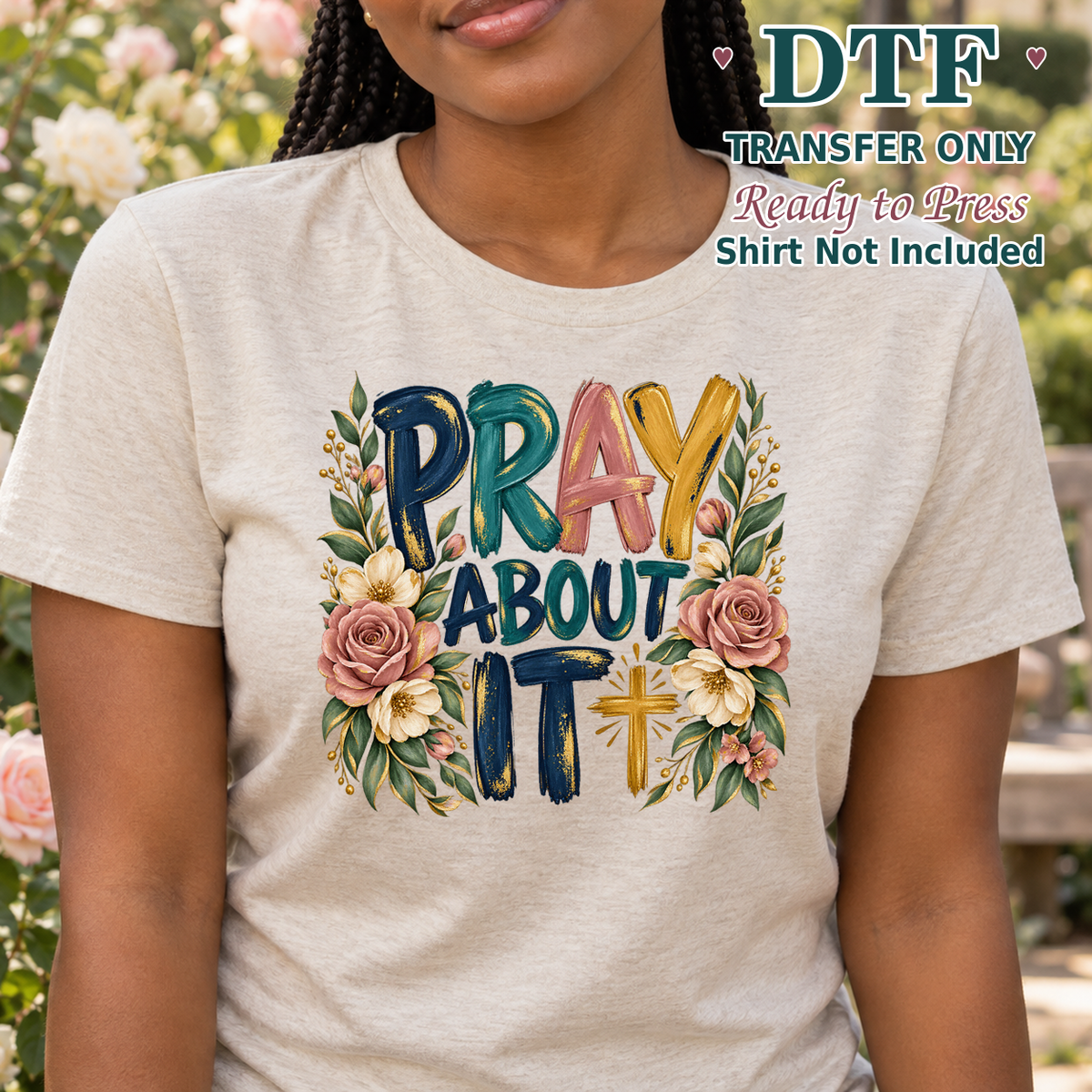 Woman in a light tee showing Pray About It lettering framed by roses and foliage.