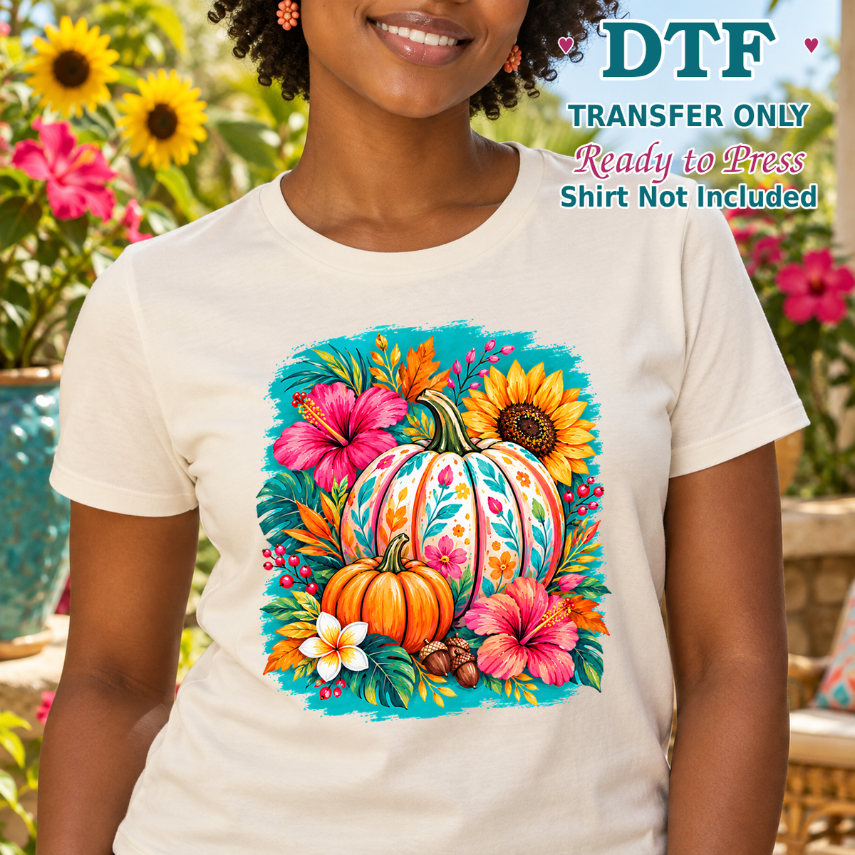Woman in a cream tee with colorful pumpkins, sunflowers and vivid pink flowers.