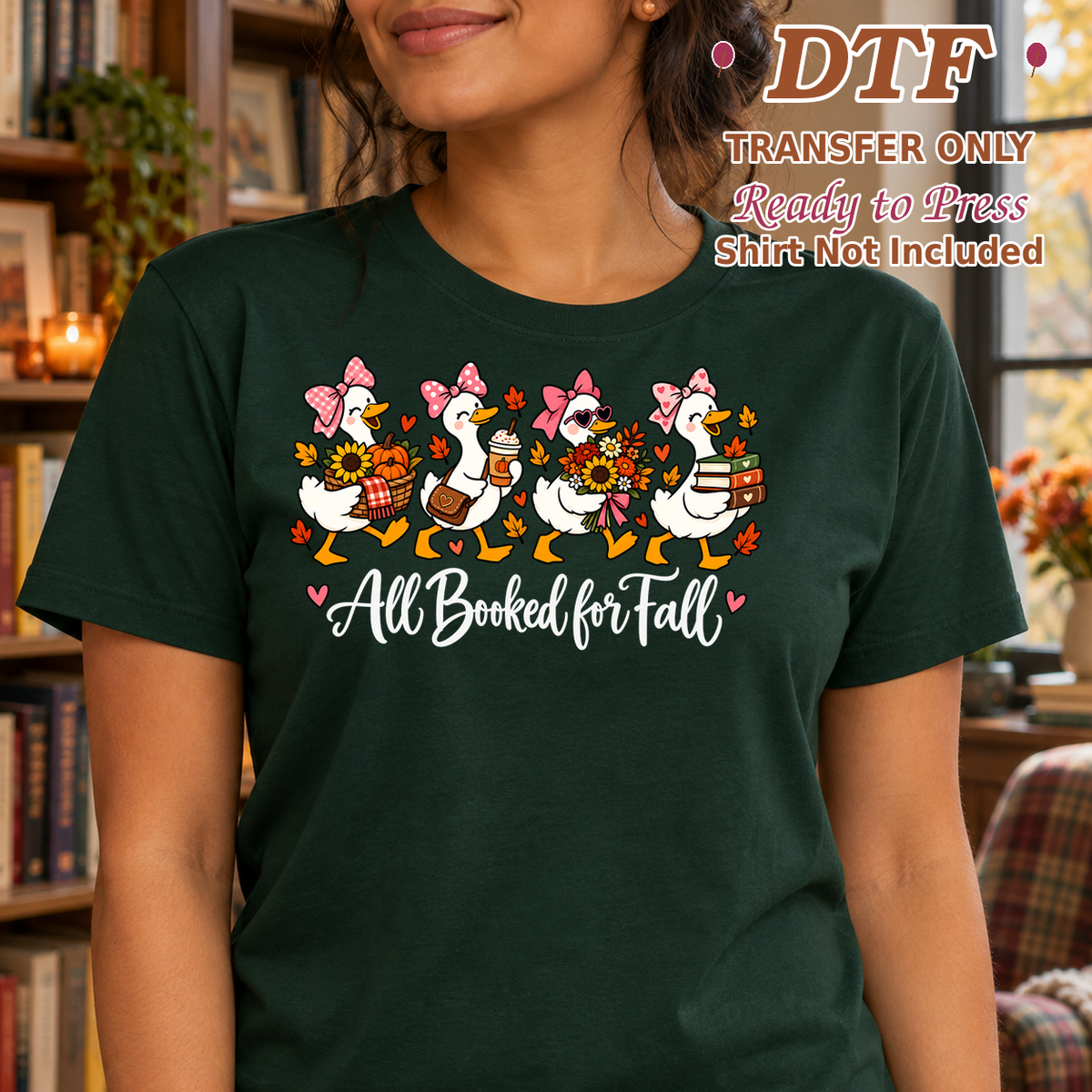 Woman in a dark green tee with reading geese and white All Booked for Fall lettering.