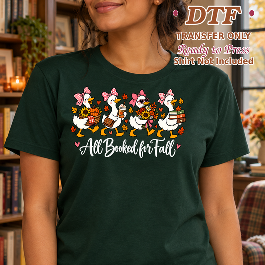 Woman in a dark green tee with reading geese and white All Booked for Fall lettering.
