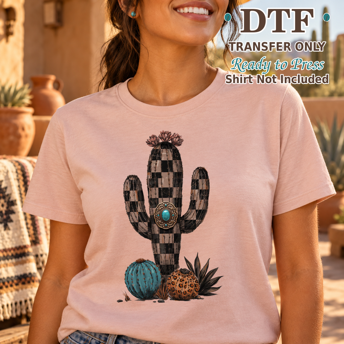 Woman in a pink tee with a checkerboard cactus, turquoise detail and patterned pumpkins.