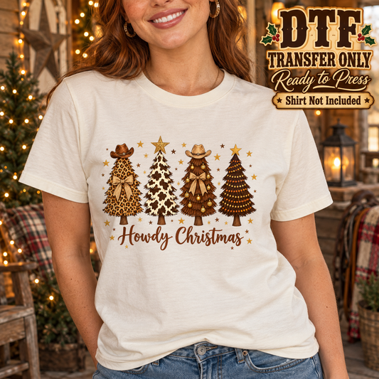 Woman in a cream tee with western-patterned Christmas trees, cowboy hats and Howdy Christmas script.