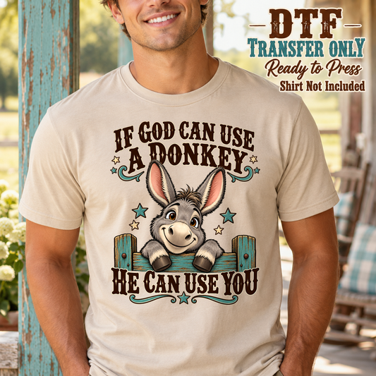 Man in a tan tee with a cartoon donkey and If God Can Use a Donkey He Can Use You text.