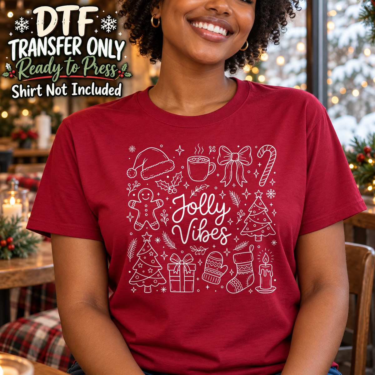 Woman in a red tee with white Jolly Vibes script and fine-line Christmas doodles.