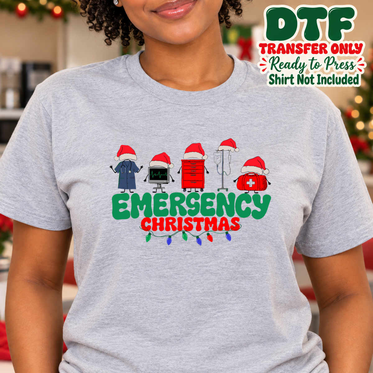 Woman in a gray tee with EMERGENCY CHRISTMAS lettering and emergency-themed icons wearing Santa hats.