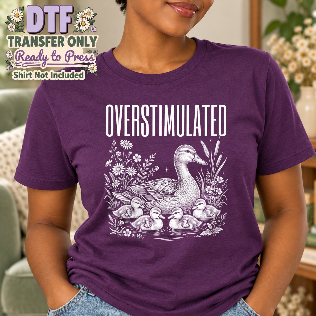 Woman in a purple tee with OVERSTIMULATED text above a goose, goslings and flowers.
