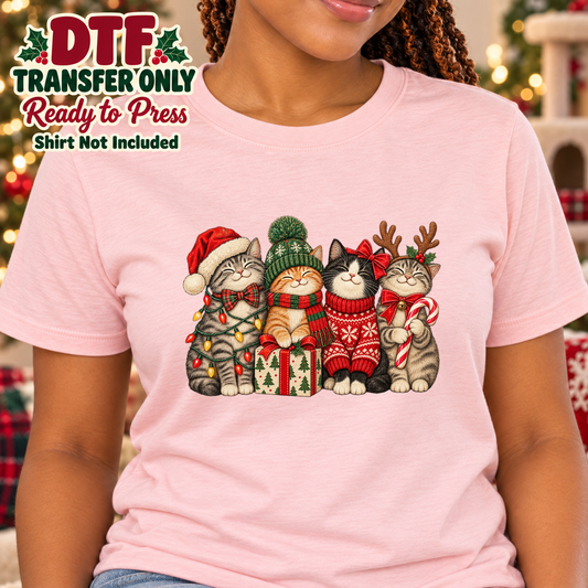 Woman in a pink tee displaying four Christmas cats in festive hats and sweaters, with transfer-only text.