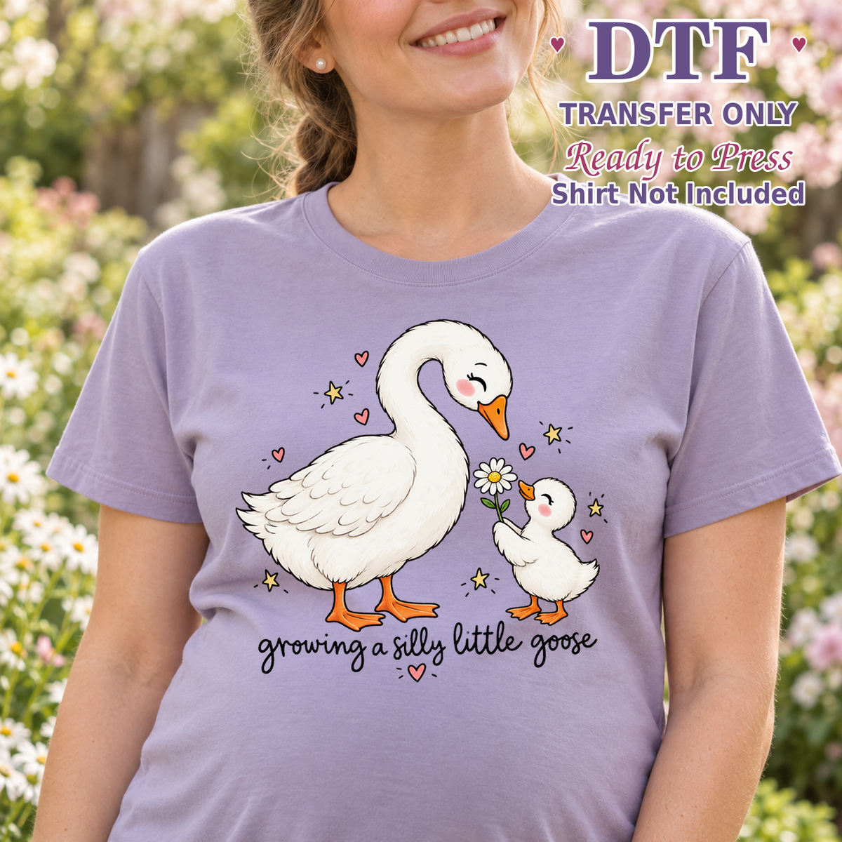 Woman in a lavender tee with a white goose, gosling, daisies and the words growing a silly little goose, labeled transfer only.