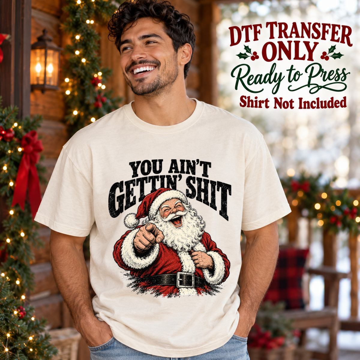 Man in an ivory tee with pointing Santa and black You Ain't Gettin' Shit wording, labeled DTF transfer only.